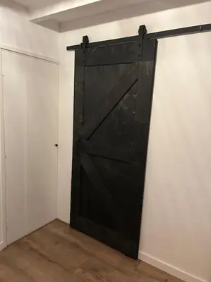 a black door in a room with white walls at Parkzicht Zwanenburg in Zwanenburg