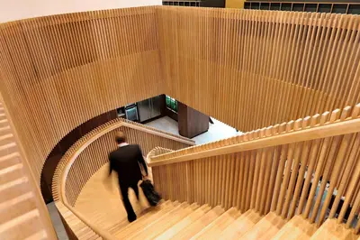 a man in a suit is walking down stairs at Courtyard by Marriott Amsterdam Arena Atlas in Amsterdam