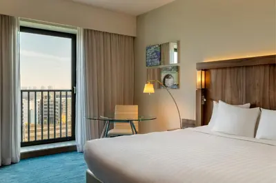 a hotel room with a bed and a large window at Courtyard by Marriott Amsterdam Arena Atlas in Amsterdam