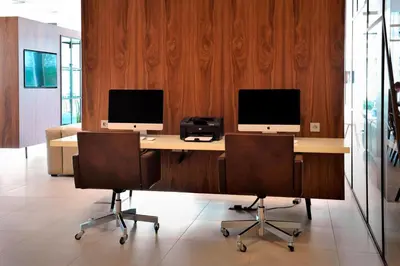 two computer monitors on a desk with two chairs at Courtyard by Marriott Amsterdam Arena Atlas in Amsterdam