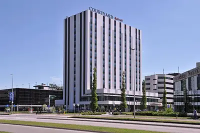 a large building with a sign on the side of it at Courtyard by Marriott Amsterdam Arena Atlas in Amsterdam