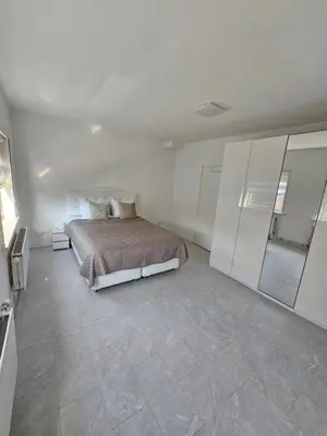 a bedroom with a bed and a tiled floor at Smile Home Wijk aan Zee 1 in Wijk aan Zee