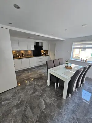 a dining room with a table and chairs and a kitchen at Smile Home Wijk aan Zee 1 in Wijk aan Zee