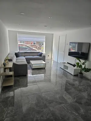 a living room with a couch and a flat screen tv at Smile Home Wijk aan Zee 1 in Wijk aan Zee