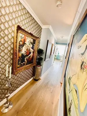 a hallway with a painting on the wall at Luxury City Center apartment with Canal view 1 kingsize bed and 1 sleeping sofa in Amsterdam