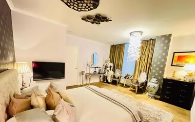 a bedroom with a large bed and a living room at Luxury City Center apartment with Canal view 1 kingsize bed and 1 sleeping sofa in Amsterdam