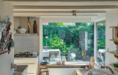 a kitchen with a large window in a room at Nice Home In Warmenhuizen With Wifi in Warmenhuizen