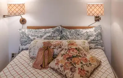a bed with two lamps and pillows on it at Nice Home In Warmenhuizen With Wifi in Warmenhuizen