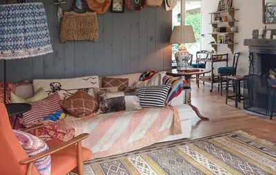 a living room with a couch with pillows on it at Nice Home In Warmenhuizen With Wifi in Warmenhuizen