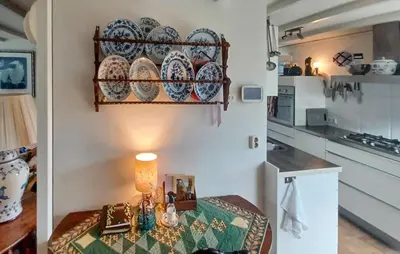 a kitchen with a table and plates on a wall at Nice Home In Warmenhuizen With Wifi in Warmenhuizen
