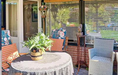 a patio with a table and chairs on a porch at Nice Home In Warmenhuizen With Wifi in Warmenhuizen