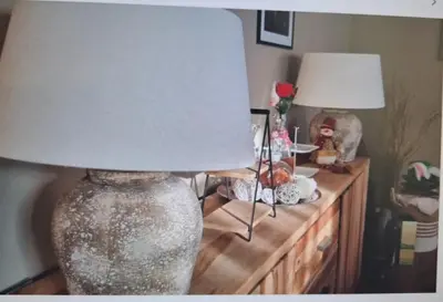 a lamp on top of a wooden table with a lampost at Cosy Apartment in Hilversum in Hilversum