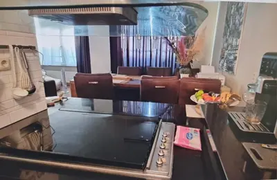 a kitchen with a stove and a dining room at Cosy Apartment in Hilversum in Hilversum