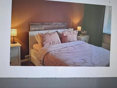 a bedroom with a bed with pink sheets and pillows at Cosy Apartment in Hilversum in Hilversum
