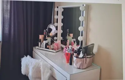 a dressing table with cosmetics and a mirror at Cosy Apartment in Hilversum in Hilversum