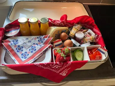 a suitcase filled with food and drinks on a table at B&B Dol - Fijn in Benningbroek