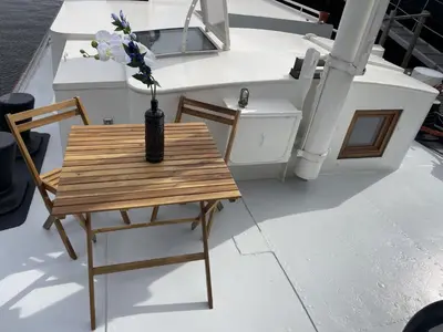 a wooden table with a vase on top of a boat at Forecastle KL in Amsterdam