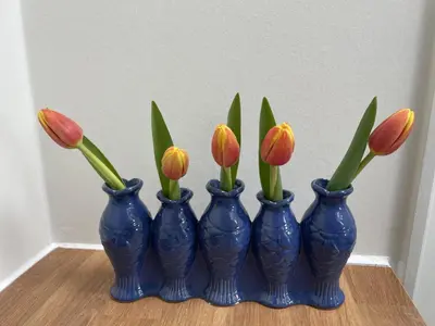 a group of blue vases with flowers in them at Forecastle KL in Amsterdam