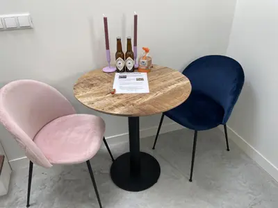 a table with two chairs and two bottles of wine at Forecastle KL in Amsterdam