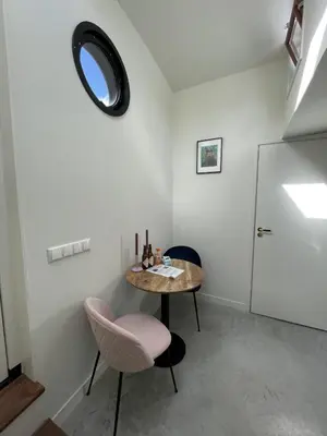 a room with a table and two chairs and a mirror at Forecastle KL in Amsterdam