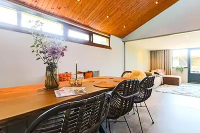 a dining room with a table and chairs at Dune Lagoon in Egmond aan den Hoef