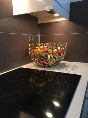 a basket of wine bottles on a counter in a kitchen at Vakantiehuis De Zeeparel in Zandvoort