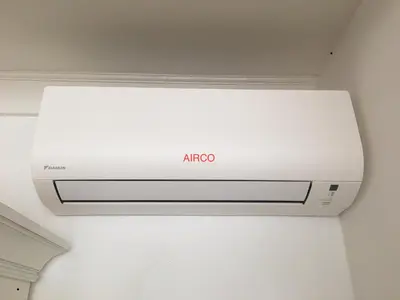a white air conditioner hanging from a ceiling at Vakantiehuis De Zeeparel in Zandvoort