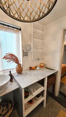 a bathroom with a counter with a sink and a window at JoyJoyJoy the Red Sun ecolicious studio in the historic Canalhouse Tropics at the Canals from 1729 in Amsterdam