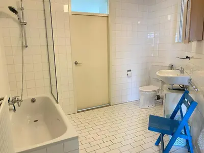 a bathroom with a tub and a sink and a toilet at Residenz Polderblick Burgerbrug in Burgerbrug