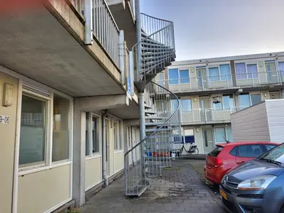 a spiral staircase on the side of a building at Residenz Polderblick Burgerbrug in Burgerbrug