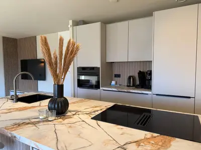 a kitchen with a counter with a vase with dry grass on it at Residenz Polderblick Burgerbrug in Burgerbrug