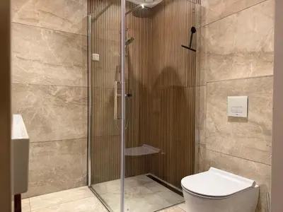 a shower stall with a toilet in a bathroom at Residenz Polderblick Burgerbrug in Burgerbrug
