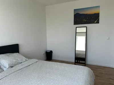 a bedroom with a bed and a mirror at Luxe Penthouse Met Panorama Uitzicht Op Natuur in Almere