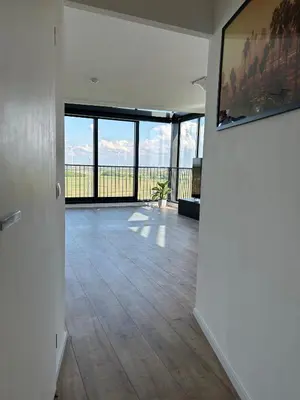 an empty living room with a view of the ocean at Luxe Penthouse Met Panorama Uitzicht Op Natuur in Almere