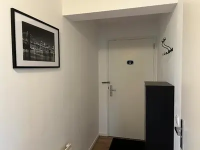 a hallway with a door and a picture on the wall at Luxe Penthouse Met Panorama Uitzicht Op Natuur in Almere