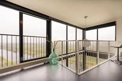 a vase sitting on the floor of a balcony at Luxe Penthouse Met Panorama Uitzicht Op Natuur in Almere
