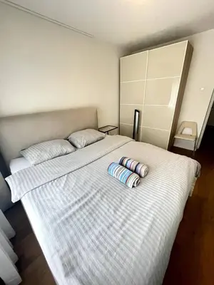 a bedroom with a bed with two pillows on it at The Amsterdam - South Apartment in Amsterdam