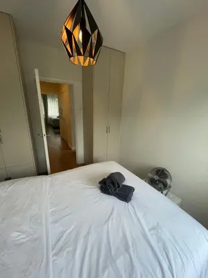 a black bow tie sitting on top of a bed at The Amsterdam - South Apartment in Amsterdam