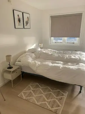 a bedroom with a large bed and a window at Have a nice stay! - Ruim appartement de Molen in Noordwijk