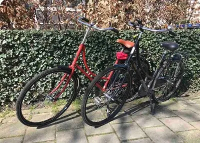 two bikes parked next to each other on a sidewalk at 1-2 pp ROOM AMS Airport great view lake in Roelofarendsveen