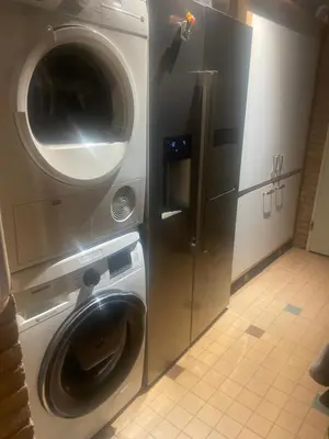 a washer and dryer next to a washing machine at 1-2 pp ROOM AMS Airport great view lake in Roelofarendsveen
