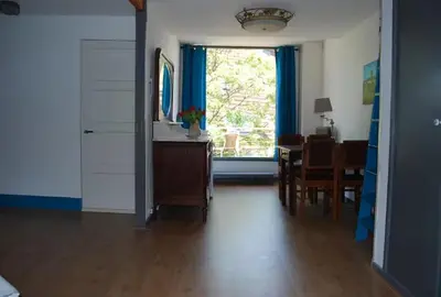 a living room with a dining table and a window at Apartement with terras in Amsterdam Noord in Amsterdam