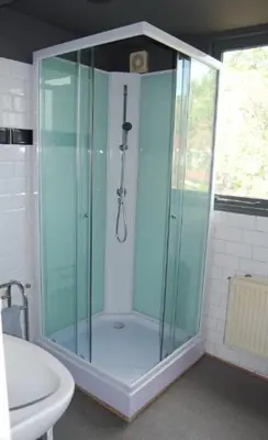 a glass shower in a bathroom with a sink at Apartement with terras in Amsterdam Noord in Amsterdam