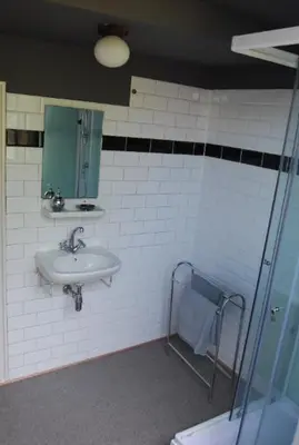 a bathroom with a sink and a shower at Apartement with terras in Amsterdam Noord in Amsterdam