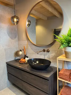 a bathroom with a black bowl sink and a mirror at 't Voorhuys Noordwijk aan Zee- tuin en gratis parkeren in Noordwijk