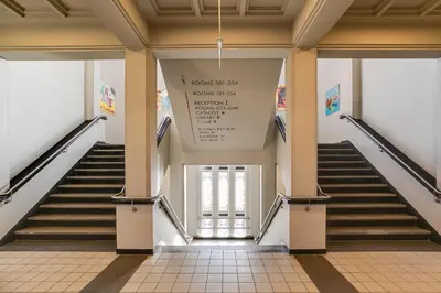 a staircase in a building with a sign on the wall at ClinkNOORD Hostel in Amsterdam