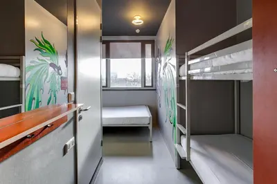 a room with two bunk beds and a window at ClinkNOORD Hostel in Amsterdam