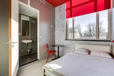a bedroom with a bed and a red ceiling at ClinkNOORD Hostel in Amsterdam