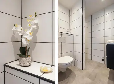 a white bathroom with a toilet and a sink at Boutique Pension Bennekom - Studio's & Apartment in Zandvoort