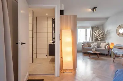 a living room with a couch and a table at Boutique Pension Bennekom - Studio's & Apartment in Zandvoort